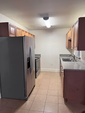 a kitchen with stainless steel appliances a refrigerator sink and stove