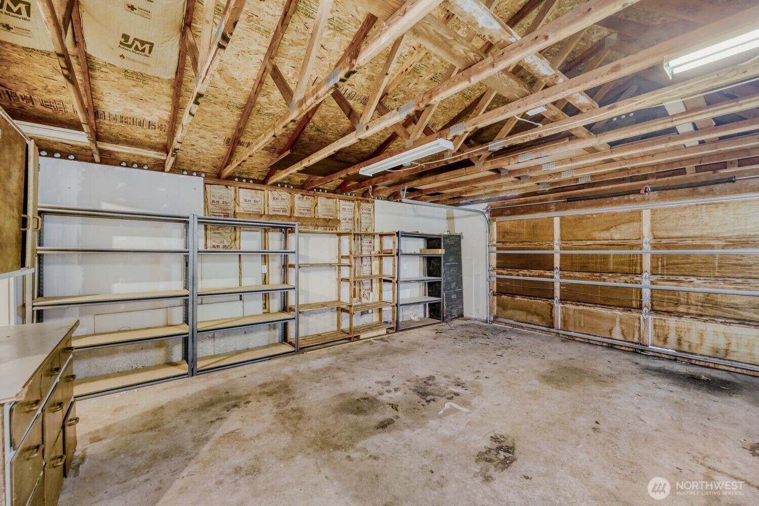 208 78th Place Southwest Everett, WA 98203 - Photo 26 of 36 a view of an empty room with wooden shelves