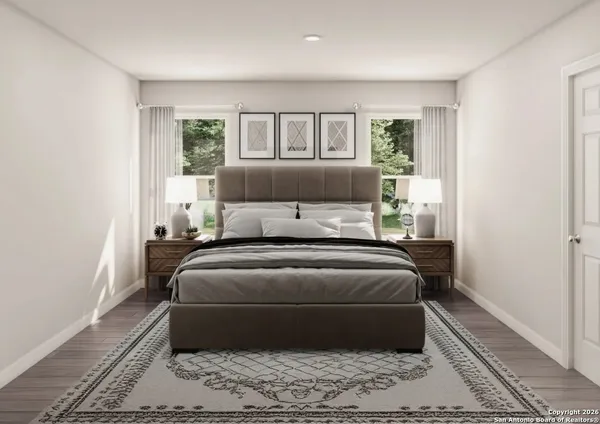 a bed sitting in a bedroom next to a window