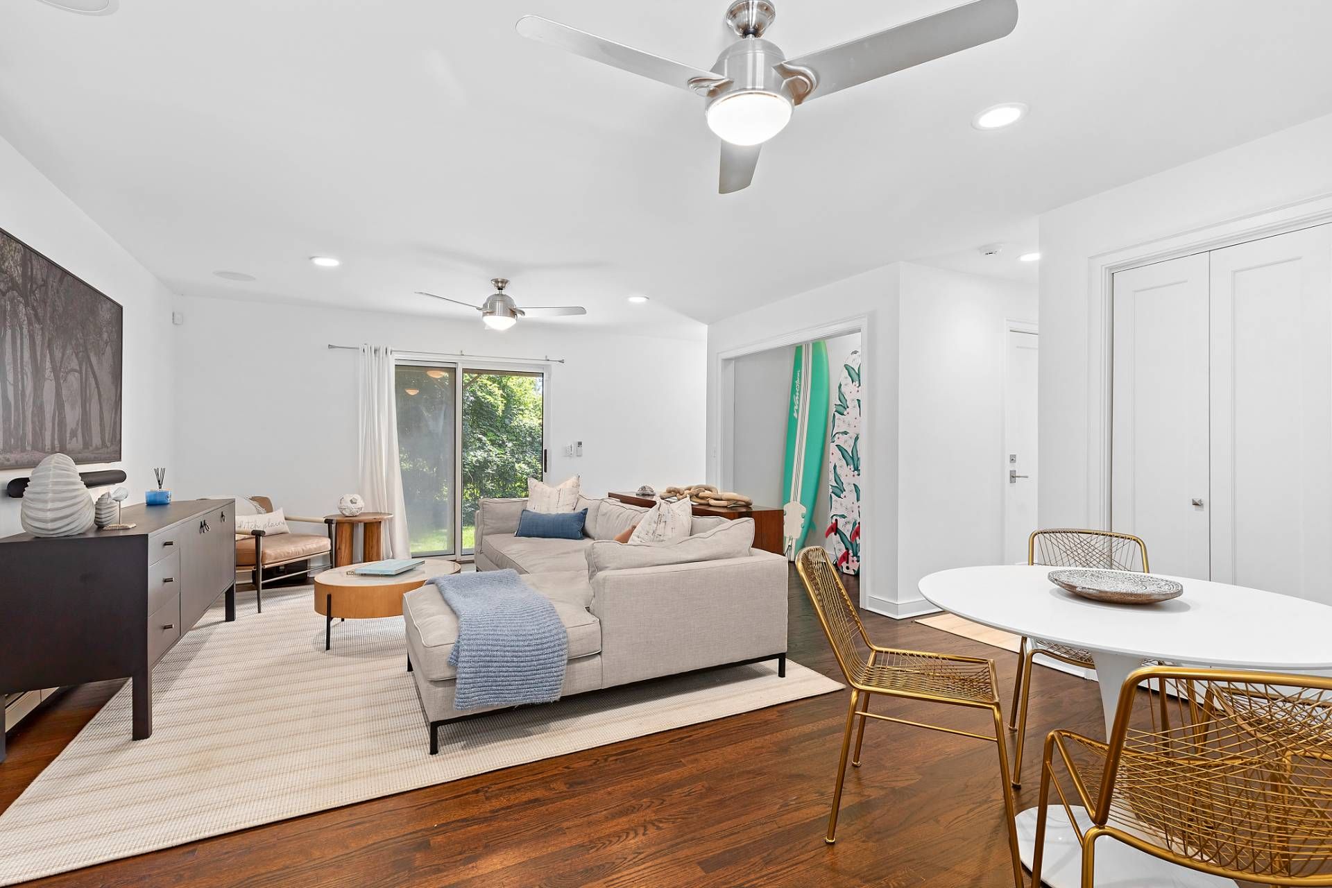 28 Ditch Plains Road Montauk, NY 11954 - Photo 6 of 30 a living room with furniture a wooden floor and chandelier