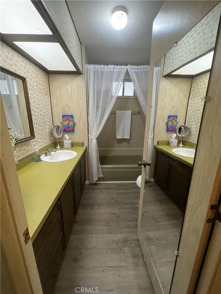 13 Palm Via Anaheim, CA 92801 - Photo 3 of 8 a bathroom with a sink mirror and a shower