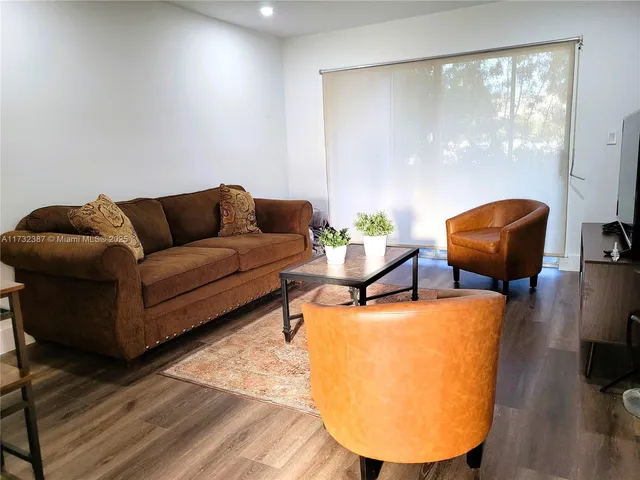 a living room with furniture and a mirror
