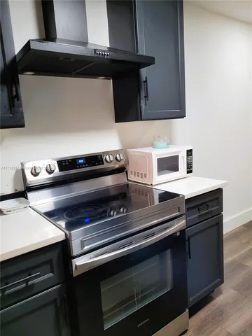 a stove top oven sitting inside of a kitchen