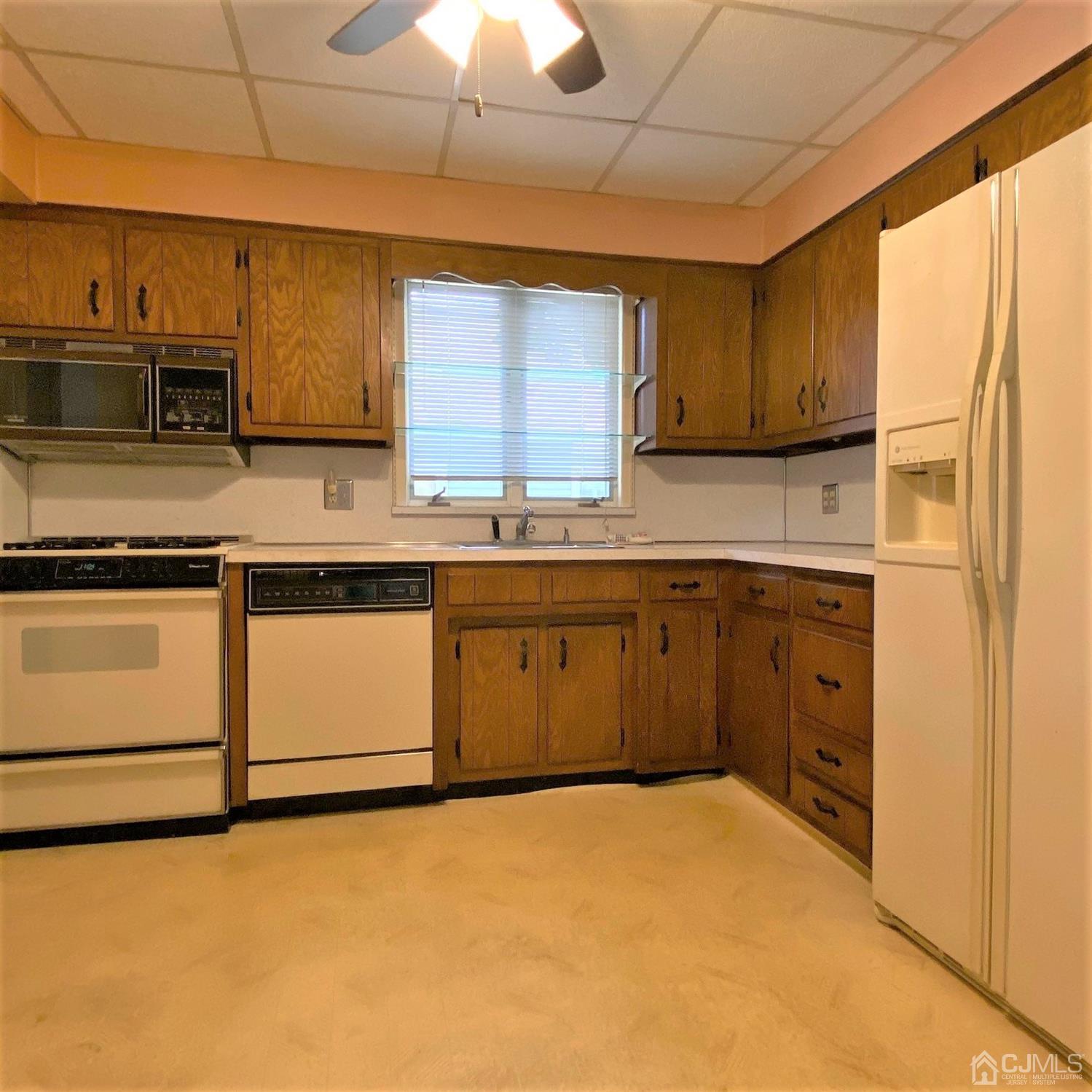 712 Center Street Dunellen, NJ 08812 - Photo 15 of 24 a kitchen with a sink stove and cabinets