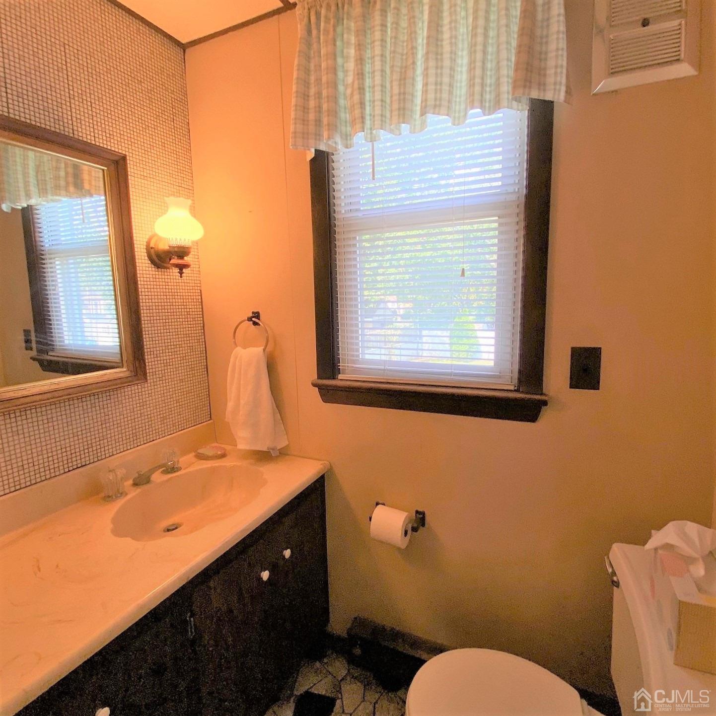 712 Center Street Dunellen, NJ 08812 - Photo 17 of 24 a bathroom with a toilet sink and mirror