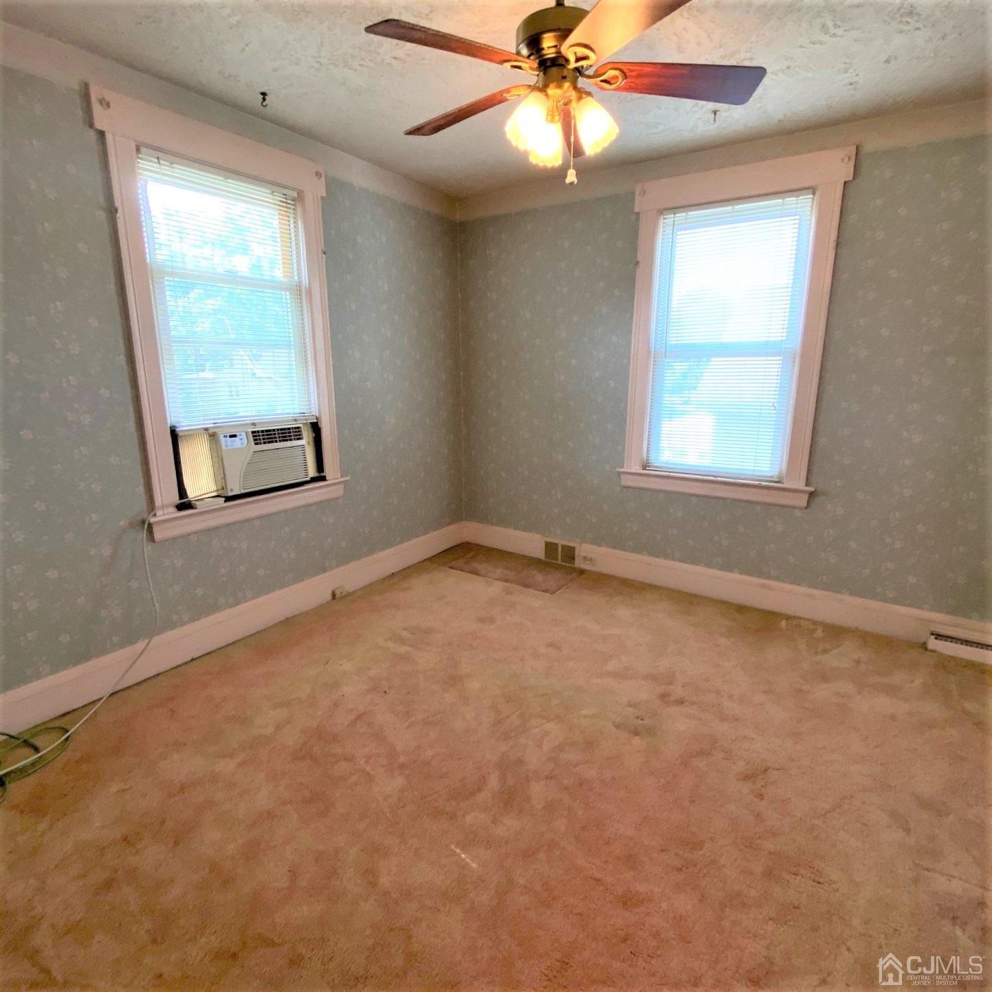 712 Center Street Dunellen, NJ 08812 - Photo 20 of 24 an empty room with a window and a fan