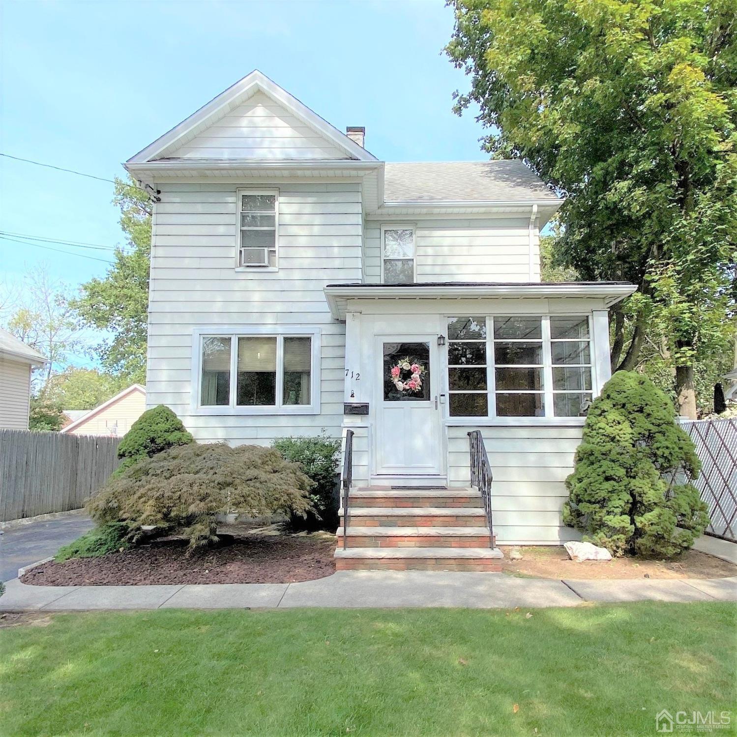 712 Center Street Dunellen, NJ 08812 - Photo 3 of 24 a front view of a house with a garden