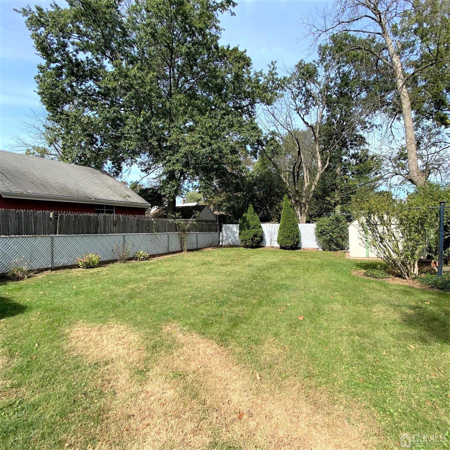 712 Center Street Dunellen, NJ 08812 - Photo 5 of 24 a view of a backyard with wooden fence