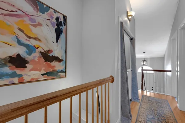 a view of a hallway with a painting on the wall