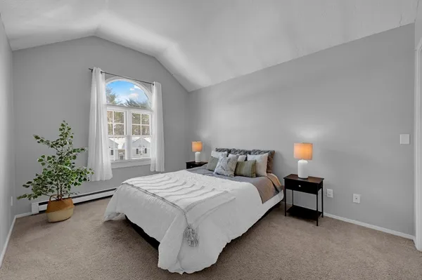 a bedroom with a bed plant and a window