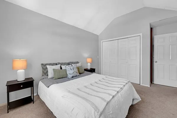 a bedroom with a bed and a lamp