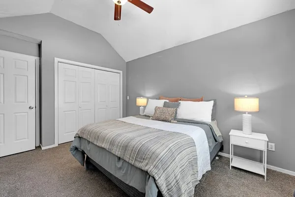 a bedroom with a bed and a lamp