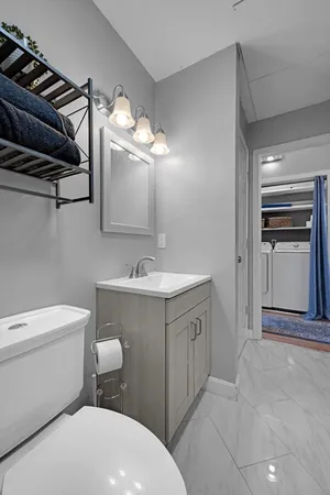 a bathroom with a sink vanity and toilet