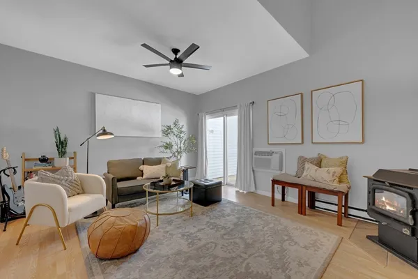 a living room with furniture a fireplace and a window