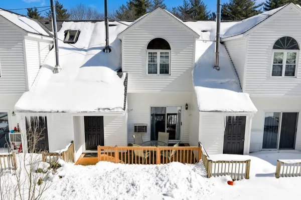 a view of a house with a yard and sitting area