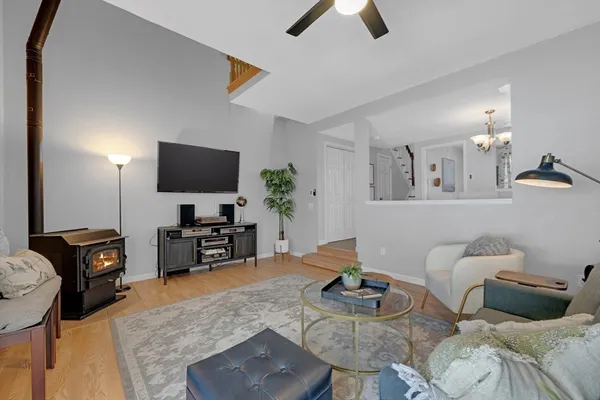 a living room with furniture a flat screen tv and kitchen view
