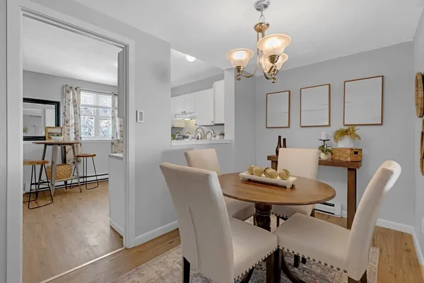 a dining room with furniture and wooden floor