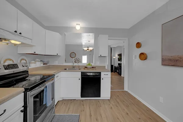 a kitchen with stainless steel appliances granite countertop a stove sink and cabinets