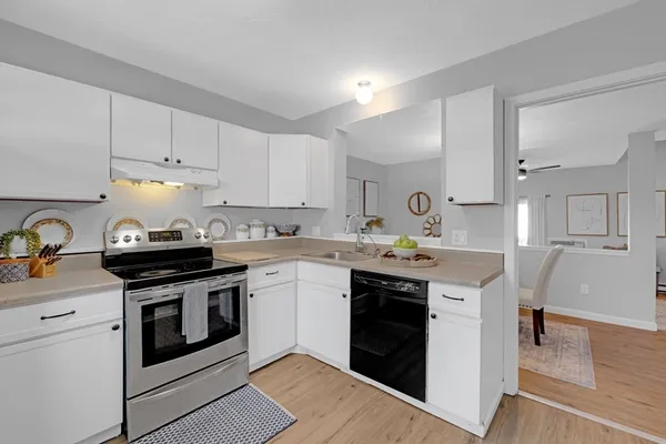a kitchen with stainless steel appliances granite countertop a stove sink and cabinets