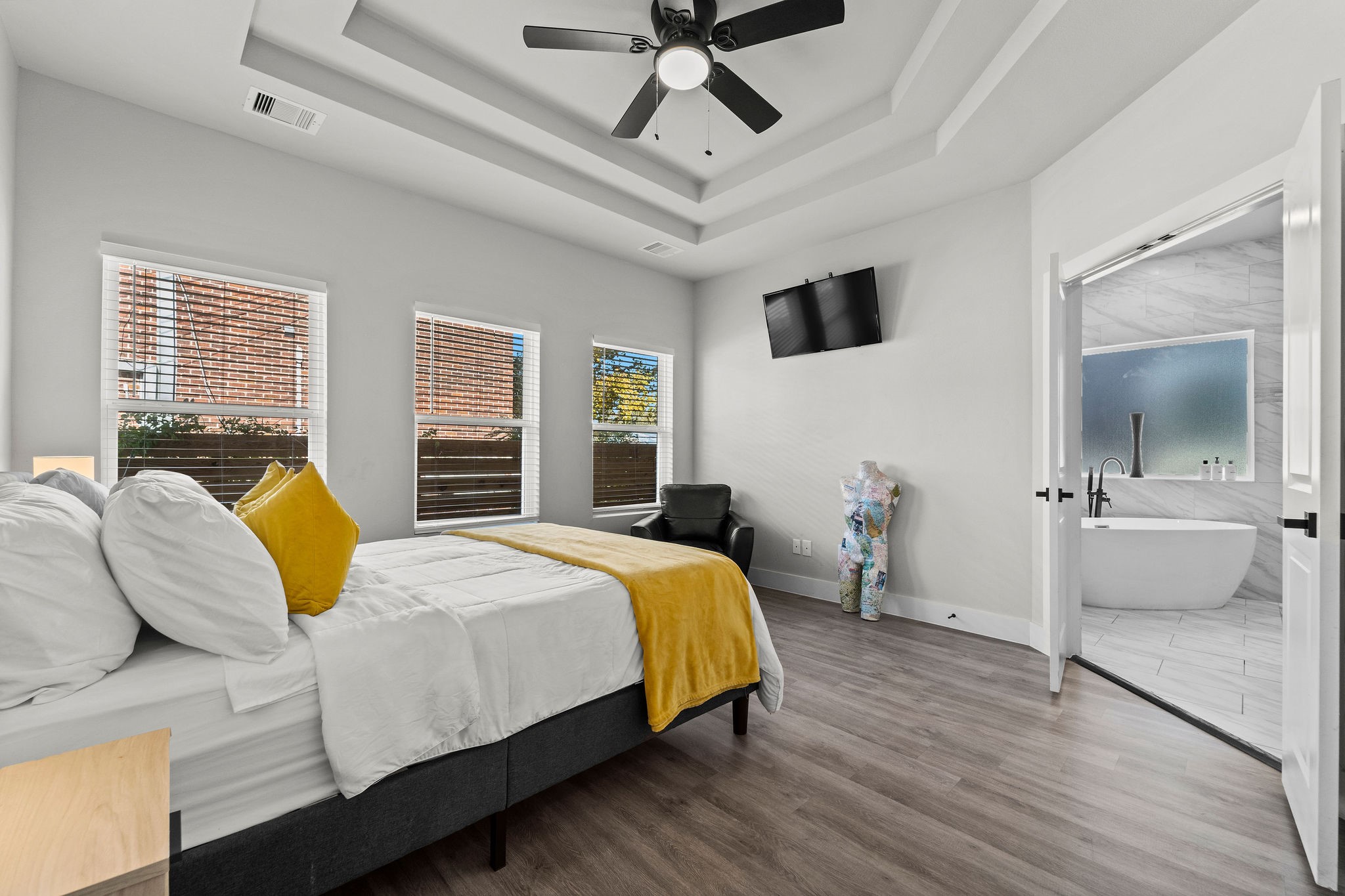 507 Carl Street Houston, TX 77009 - Photo 15 of 24 a bedroom with a bed and a flat screen tv