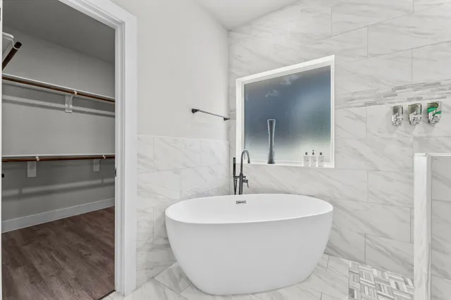 a spacious bedroom with a bed and couch