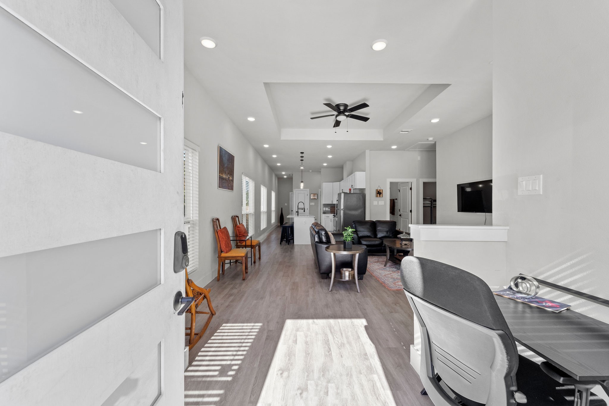 a living room with furniture and wooden floor