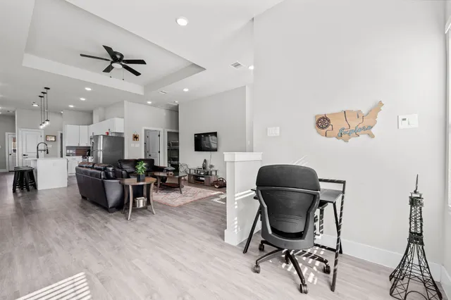 a living room with furniture and wooden floor