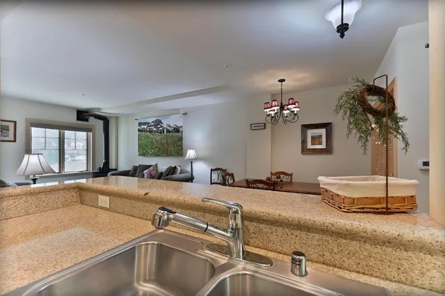 a reception area with glass top table and sofas