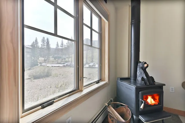 a living room with a flat screen tv and a floor to ceiling window
