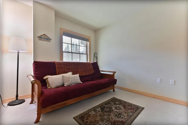 a living room with furniture and a rug