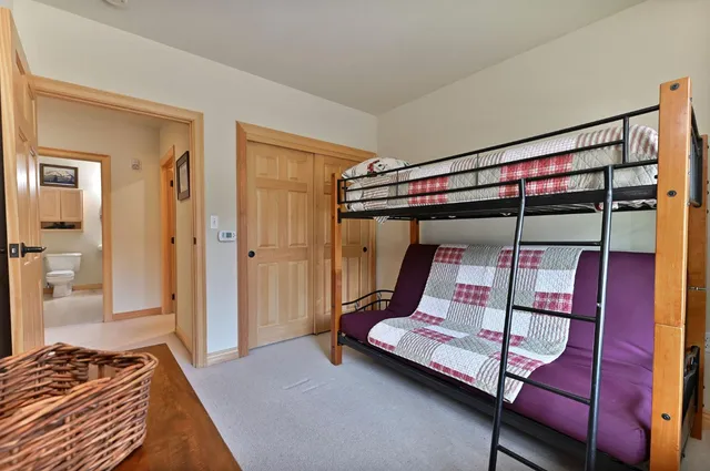 a bedroom with a bunk bed and a mirror