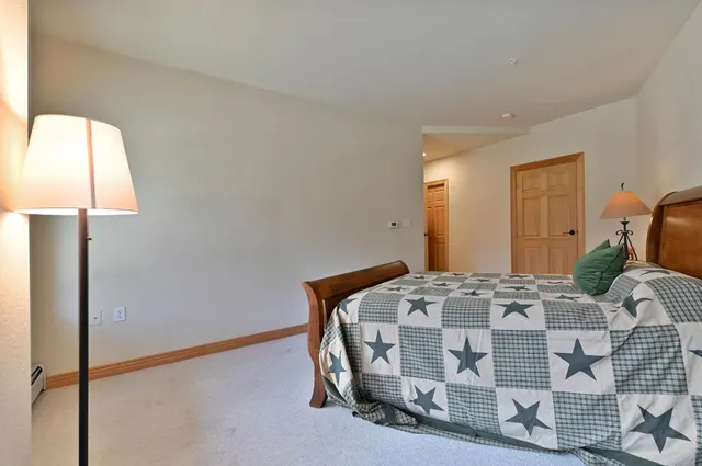 a bedroom with a bed and a lamp