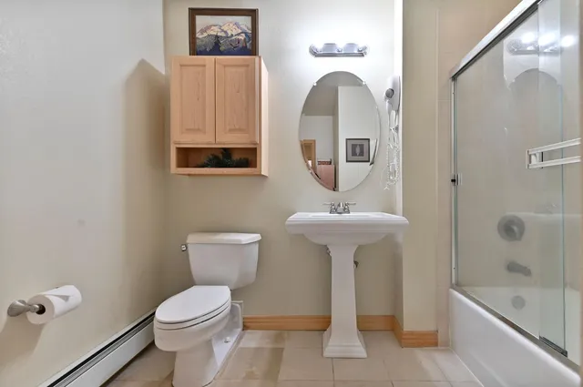 a bathroom with a toilet a sink and bathtub