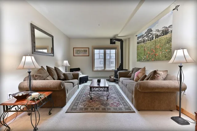 a living room with furniture a lamp and a window