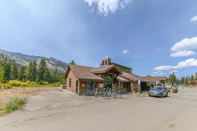 a front view of a house with a yard and table and chairs