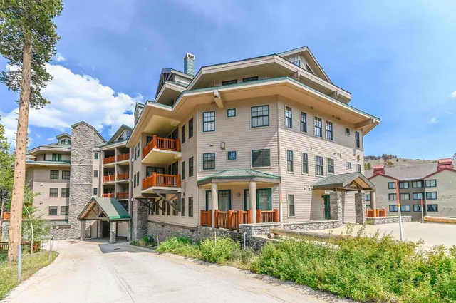 a front view of a building with a garden