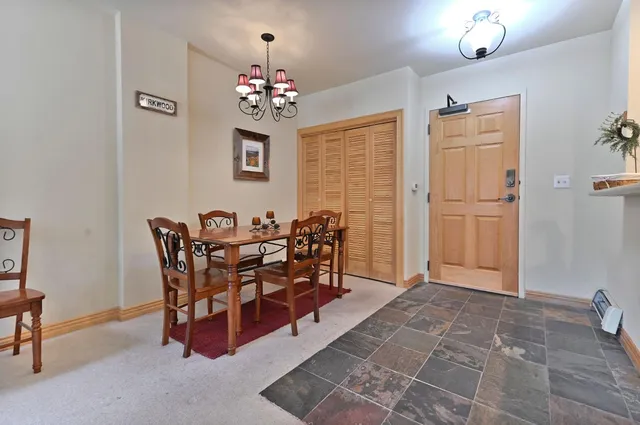 a view of a dining room with furniture and chandelier