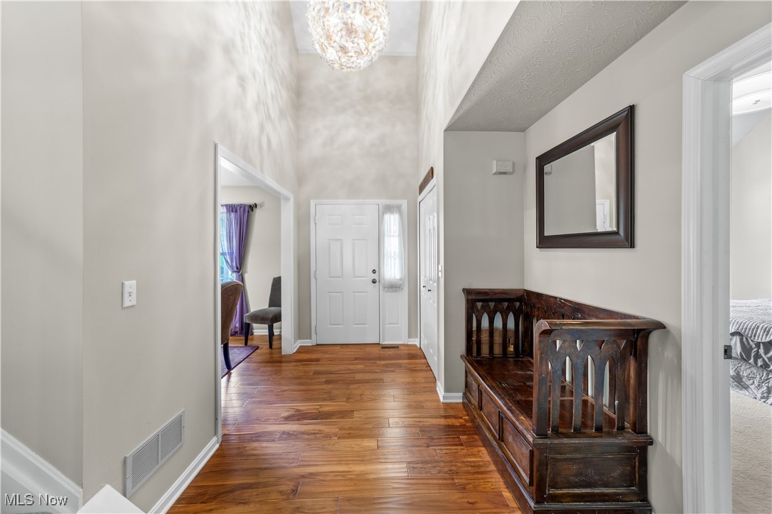 30825 Cannon Road Solon, OH 44139 - Photo 3 of 49 Entryway with a chandelier and dark wood-style floors
