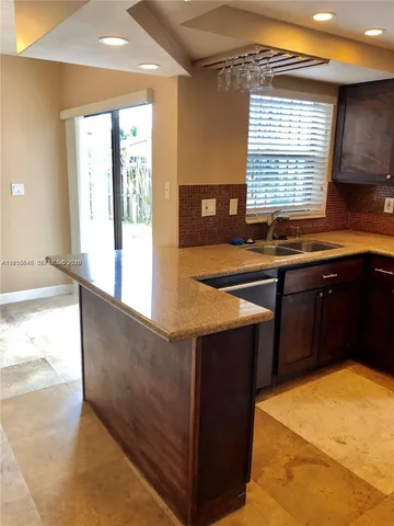 a kitchen with stainless steel appliances granite countertop a sink counter space and a window