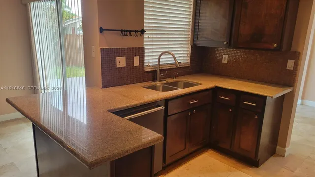 a kitchen that has a sink and a window