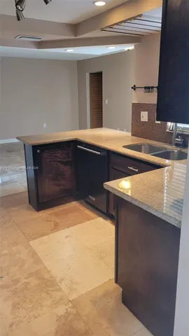 a kitchen with a sink and a mirror