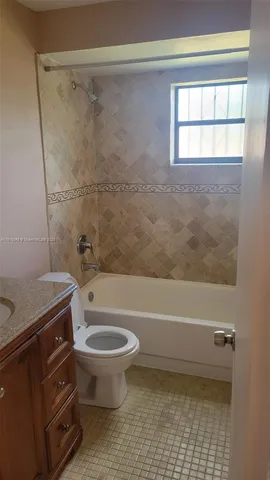 a bathroom with a toilet a sink and a bathtub