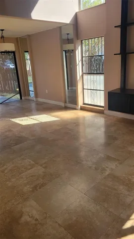 an empty room with large windows