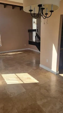 a view of room with window and wooden floor