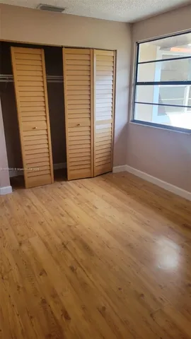 a view of a hallway and a mirror in a room
