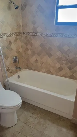 a bathroom with a toilet and a bathtub