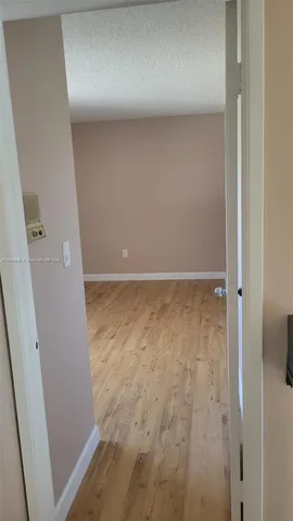 an empty room with wooden floor