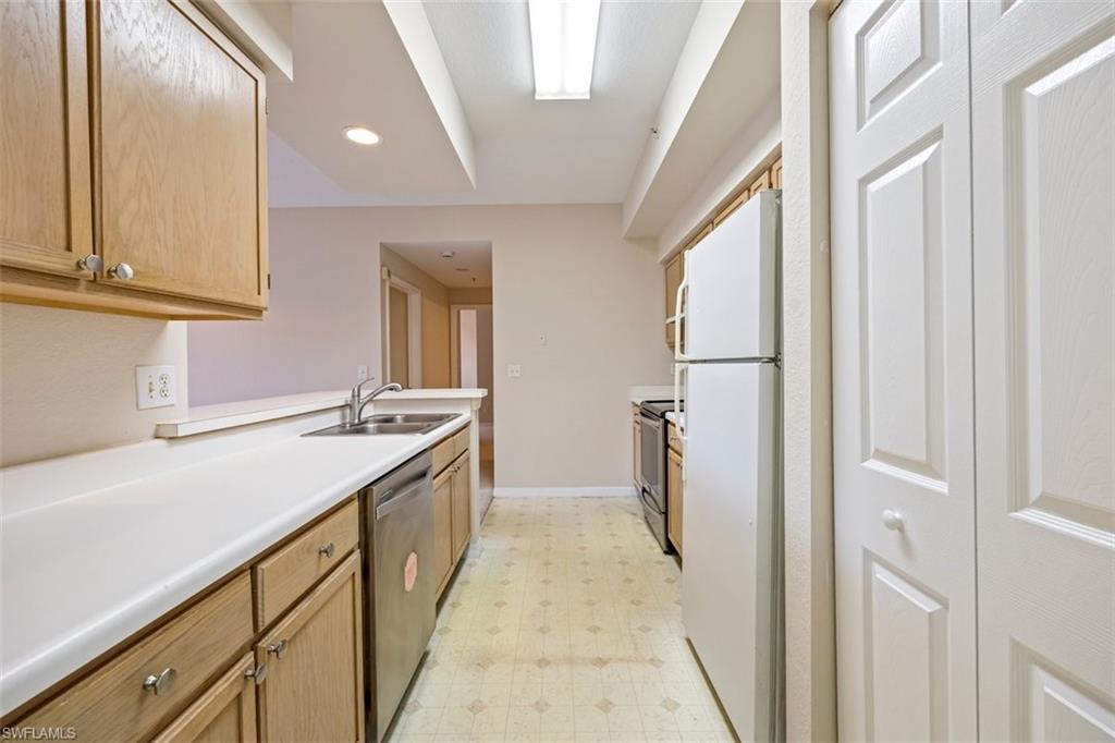 4635 St Croix Lane, Unit 1218 Naples, FL 34109 - Photo 11 of 40 Kitchen with appliances with stainless steel finishes, light flooring, light countertops, and recessed lighting