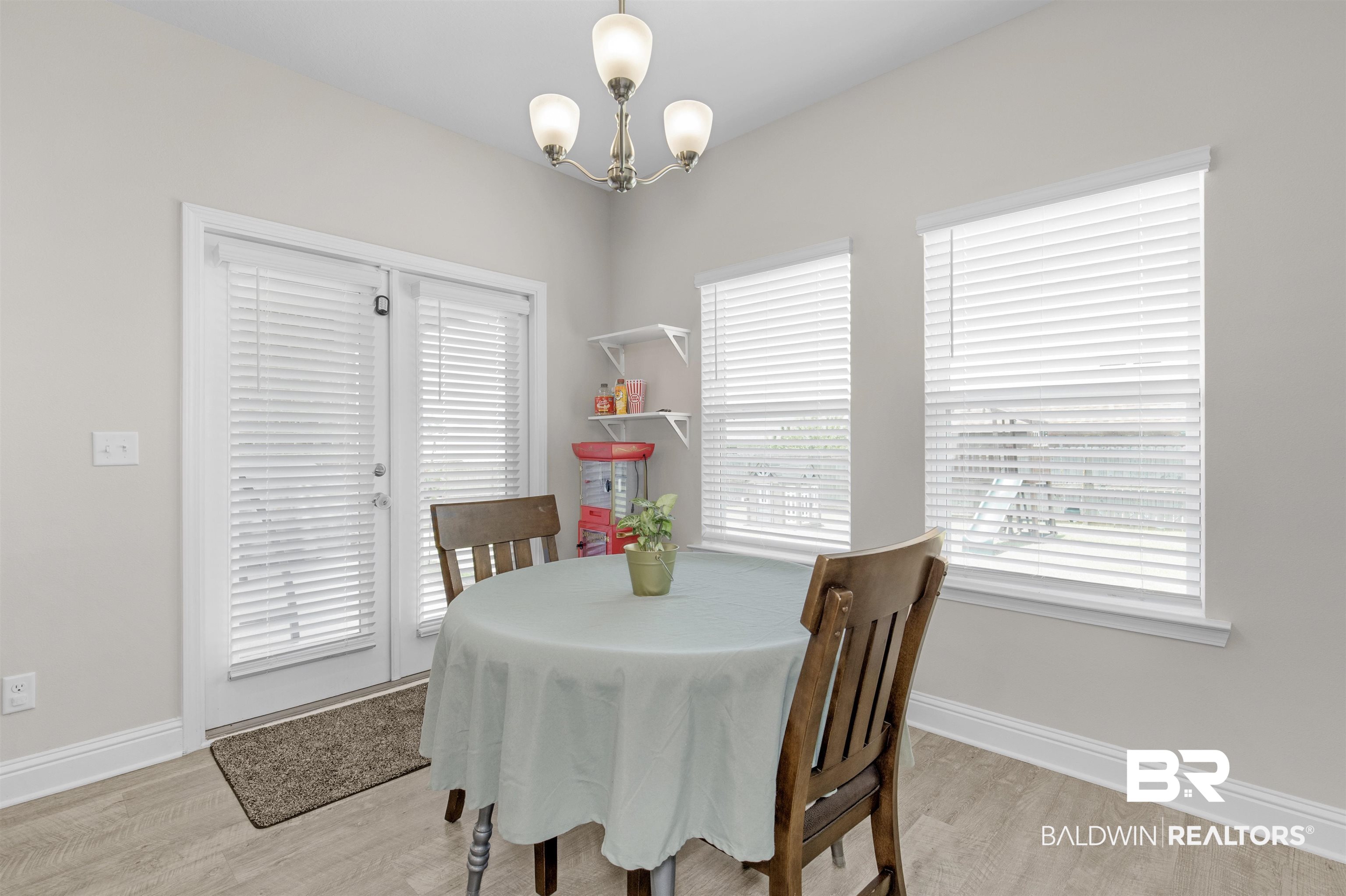 2345 Laurel Street Semmes, AL 36575 - Photo 11 of 31 Dining room featuring wood finished floors and a chandelier