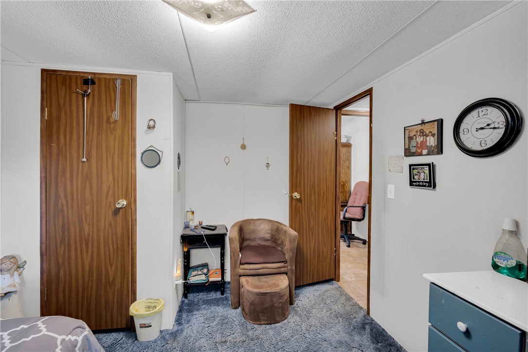 162 Newberry Road Walhalla, SC 29691 - Photo 23 of 50 A well-lit room offers cozy carpeted floors and warm wood doors, perfect for comfortable living.